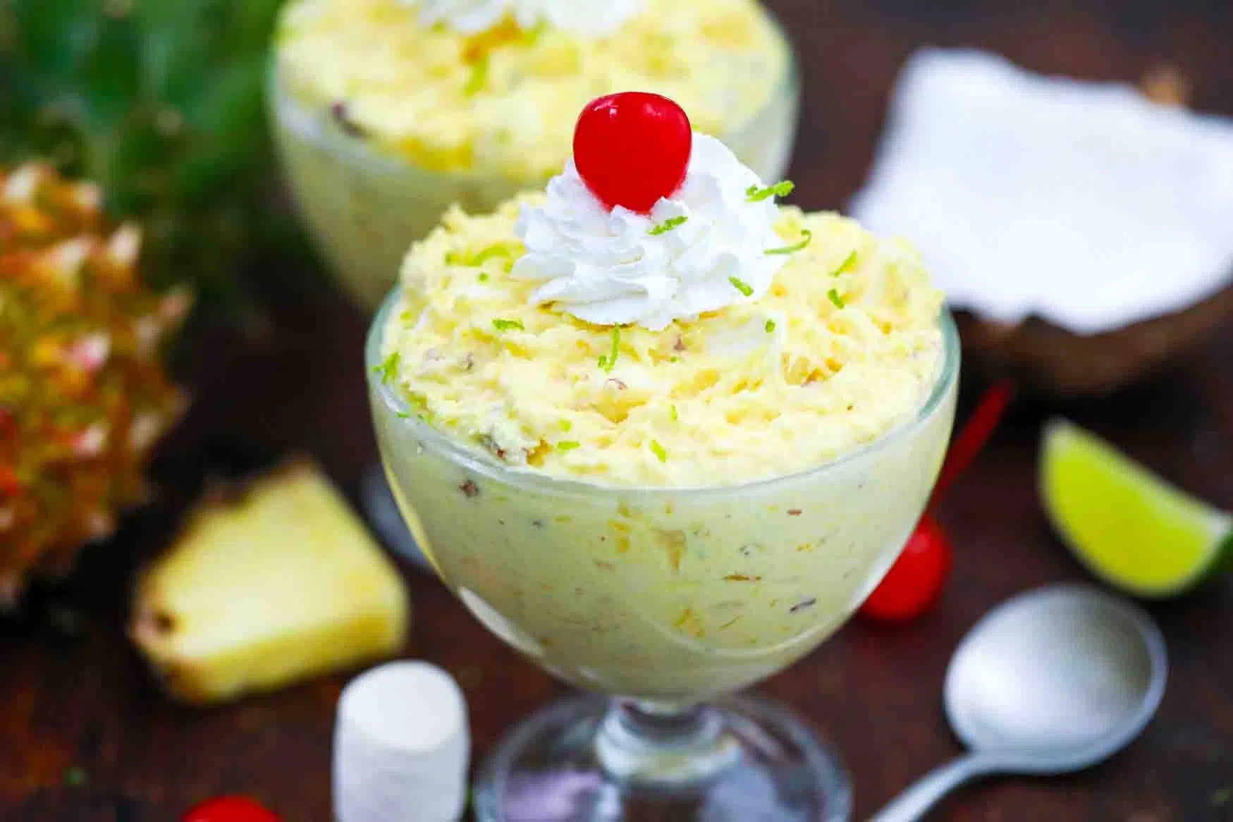 pineapple fluff topped with whipped topping and a cherry