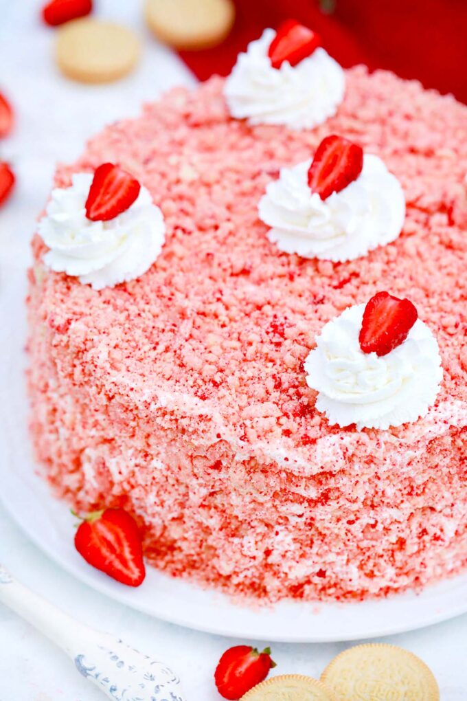 Strawberry crunch cake topped with strawberry crumbs.