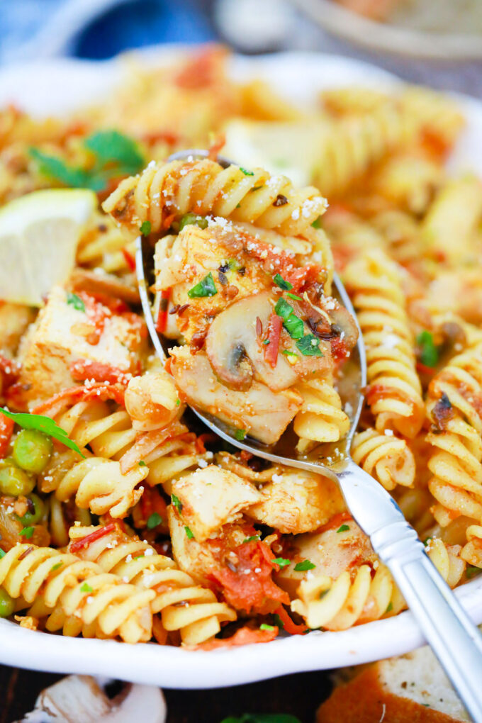 A spoonful of Indian curry pasta salad with fusili pasta.