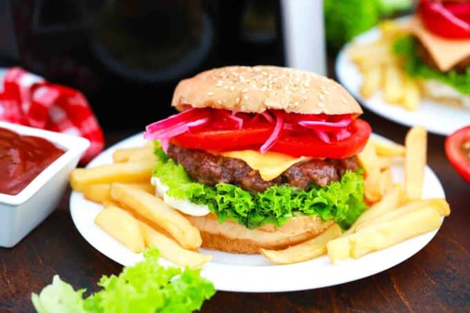 air fryer cheeseburgers with French fries onion lettuce and tomatoes