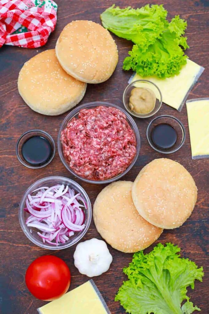 overhead shot of ground beef and burger fixings on a table