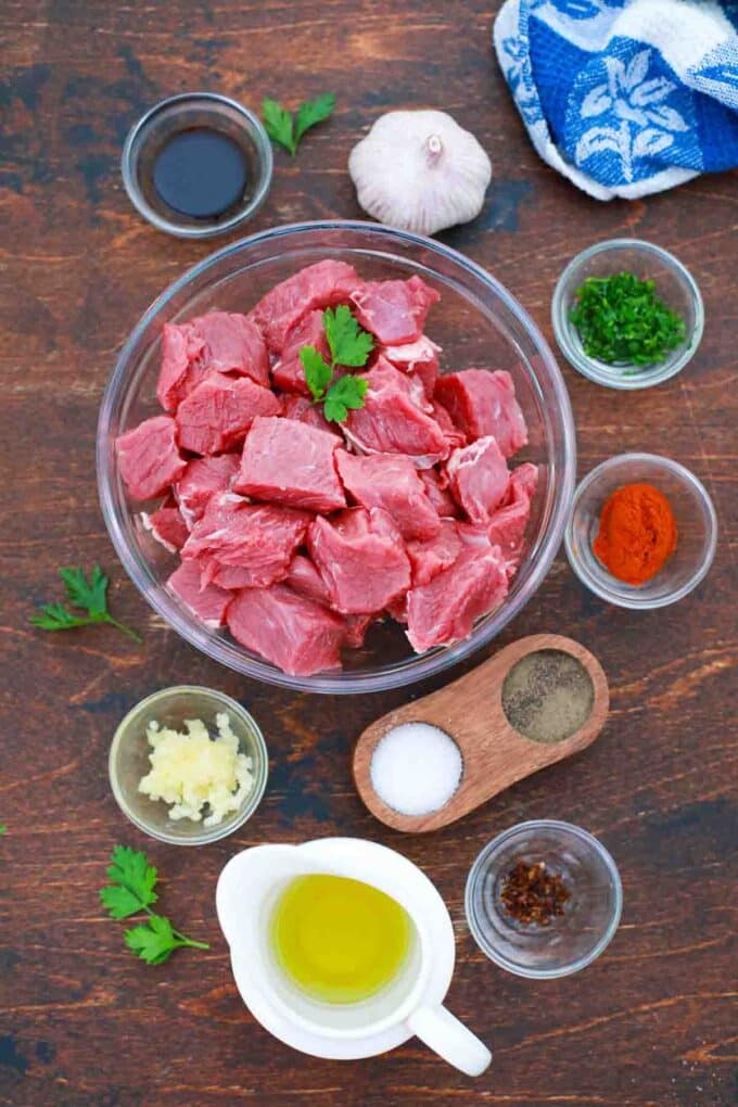 cubed steak and spices in bowls on a table