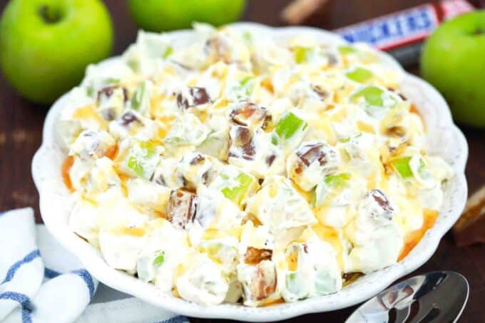 a bowl of apple snickers salad with green apples