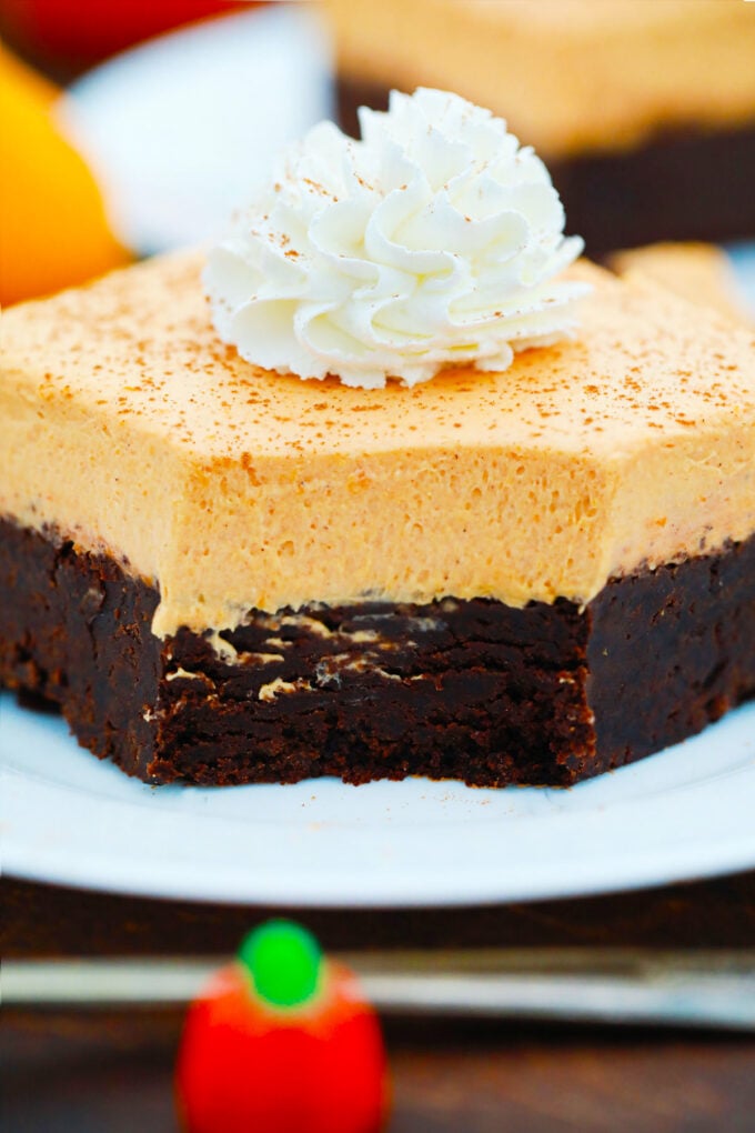 Pumpkin mousse brownies topped with whipped cream.