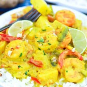 rice topped with pineapple coconut shrimp curry and fresh lime