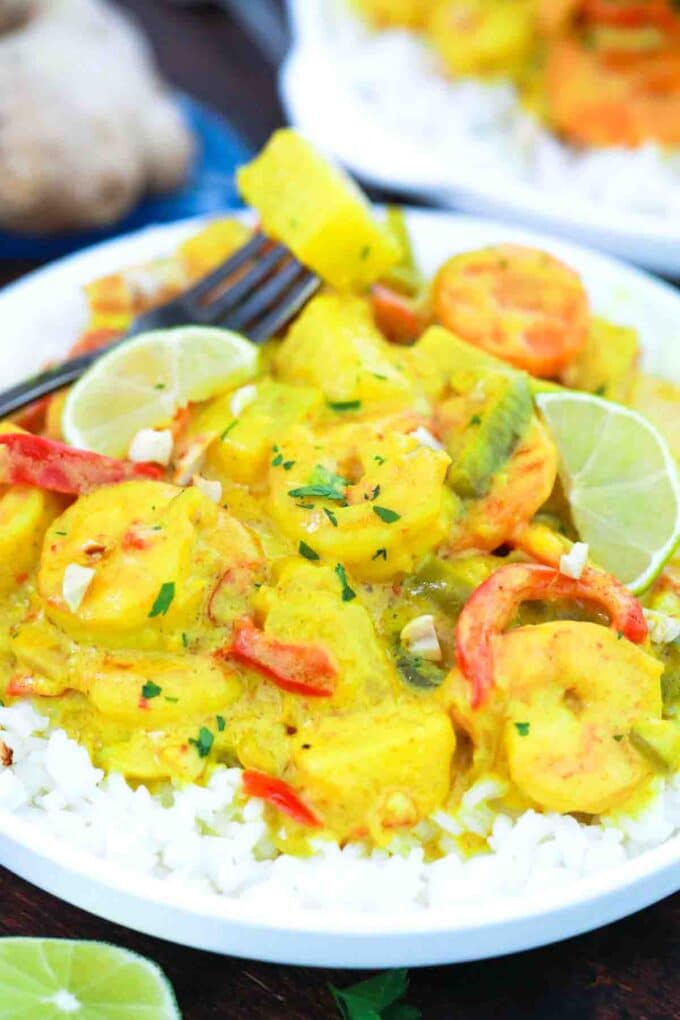 rice topped with pineapple coconut shrimp curry and fresh lime