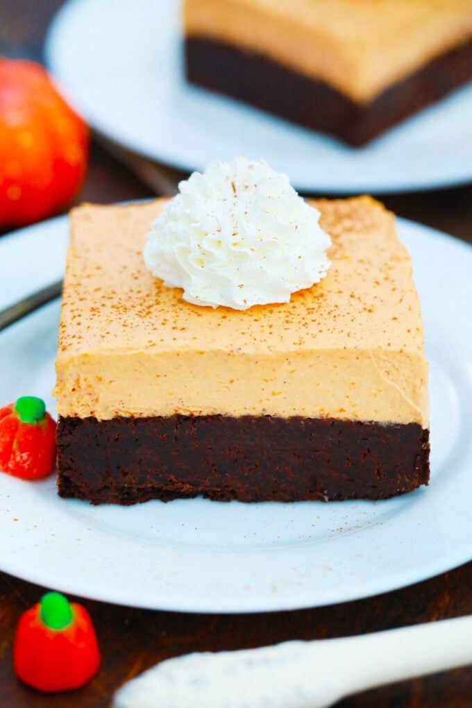 Creamy pumpkin mousse brownies with whipped cream.