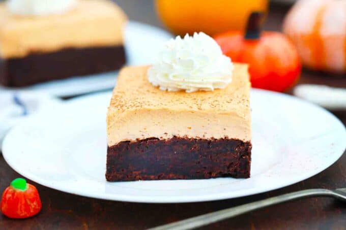 pumpkin mousse brownies topped with whipped cream