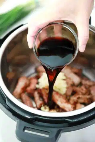 adding soy sauce to the pressure cooker