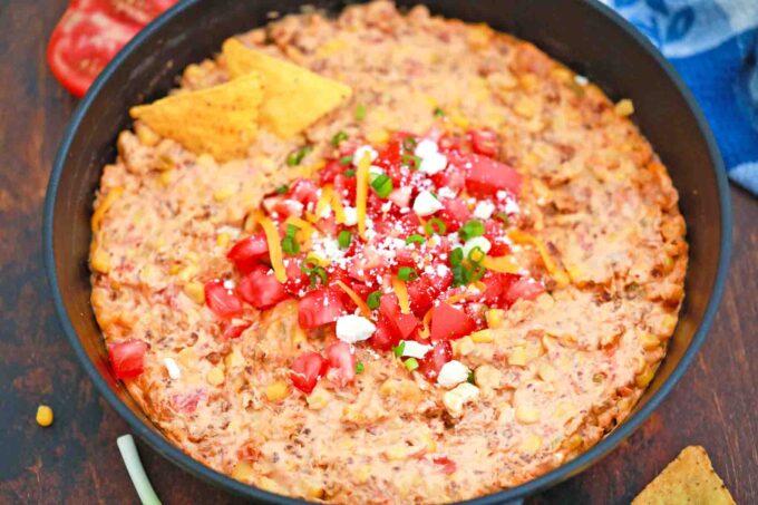 sausage queso dip in a cast iron skillet