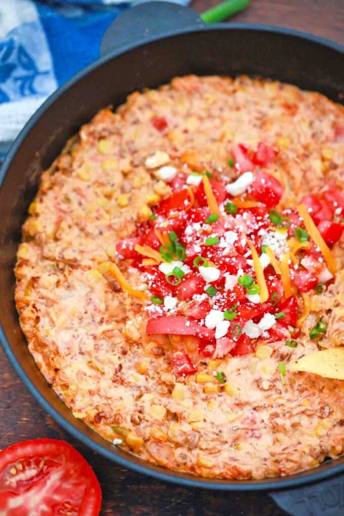 cast iron skillet of sausage queso dip