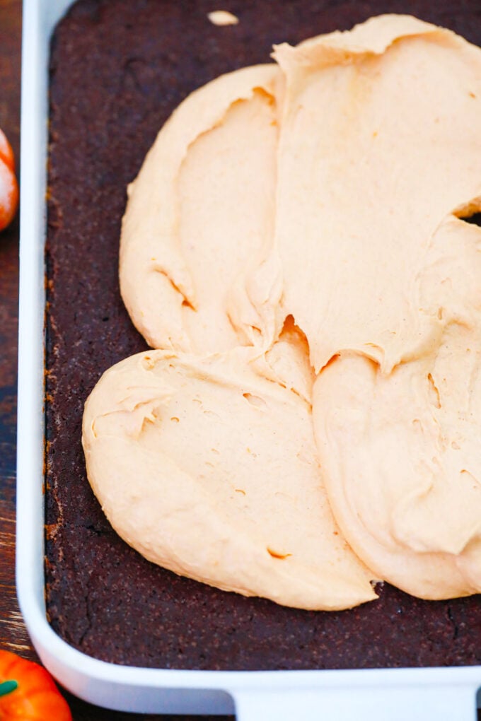 Spreading pumpkin mousse over brownies.