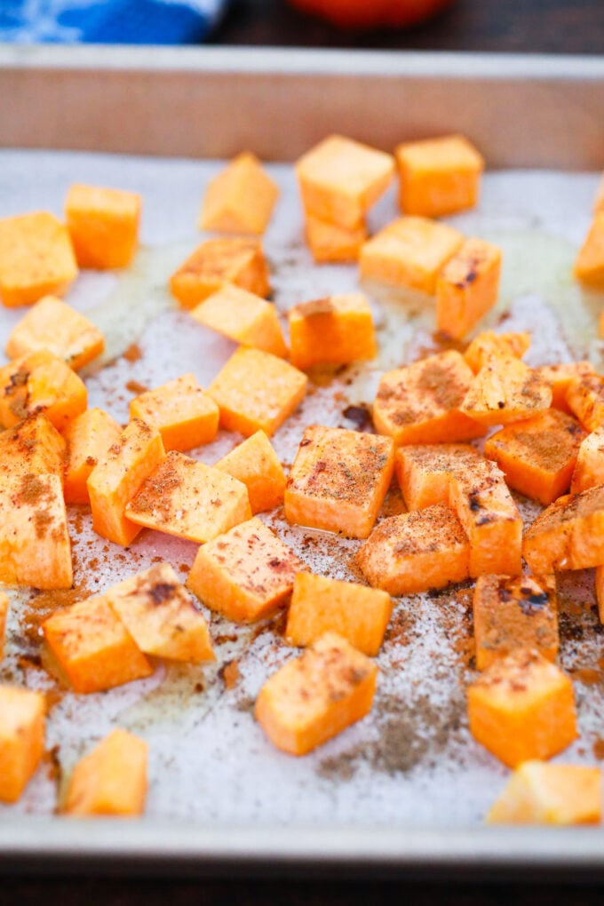 Squash cubes on a baking sheet.