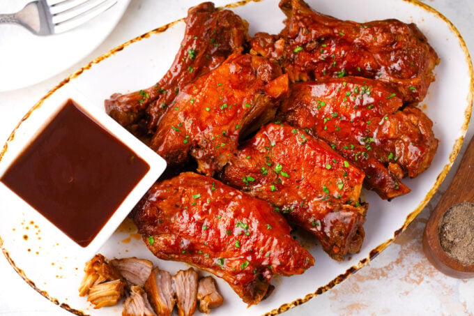 A plate of Instant Pot country style ribs with BBQ sauce.