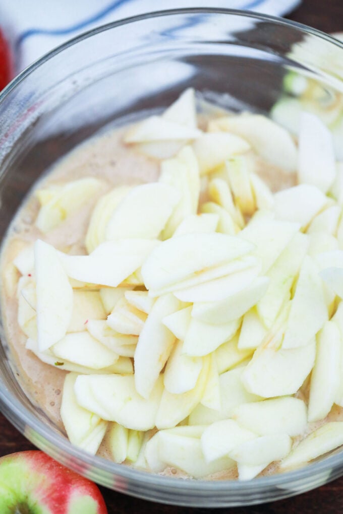 Folding apples into cake batter.