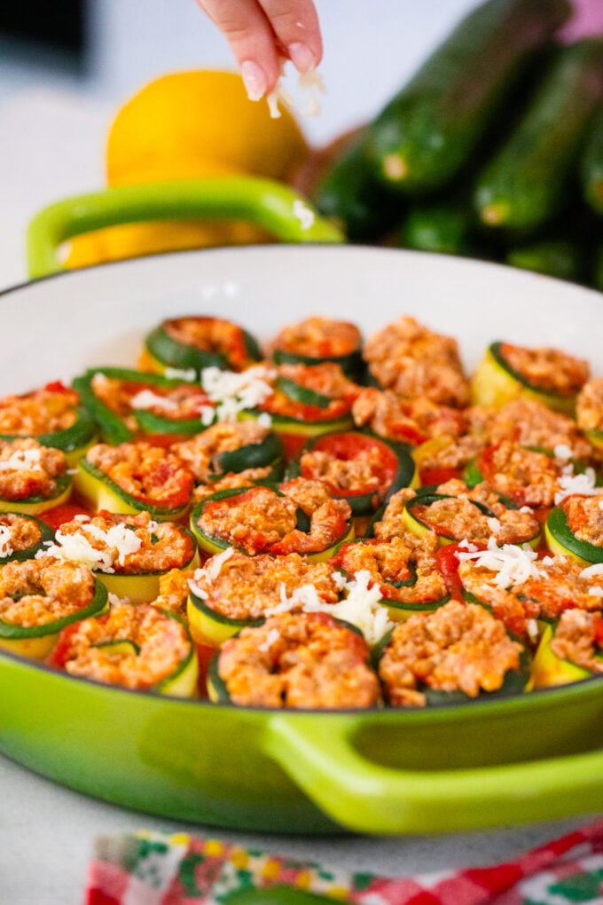 Baking zucchini lasagna rollups.