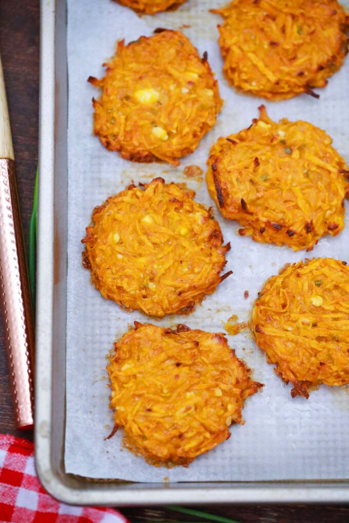 Oven baked sweet potato fritters on a baking sheet.