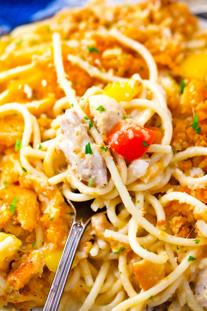 A close shot of a forkful of baked chicken spaghetti casserole.