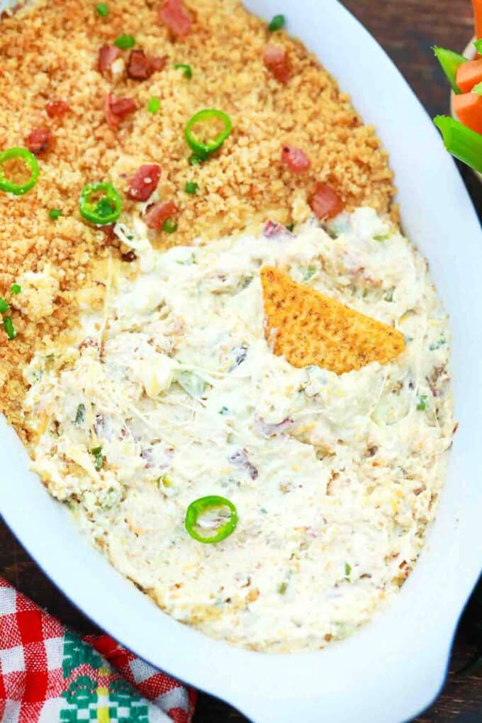overhead shot of creamy baked jalapeno popper dip in a baking dish