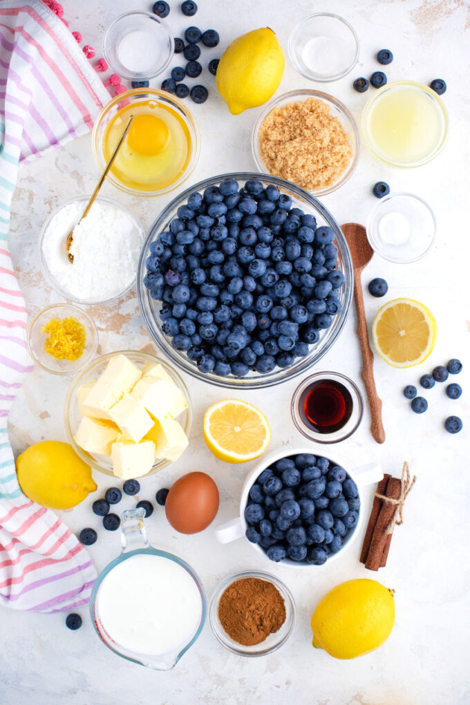 Overhead shot of blueberry coffee cake ingredients in bowls on a table.