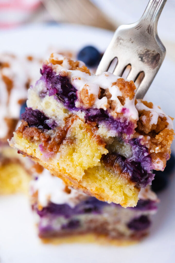 A bite of blueberry coffee cake on a fork.