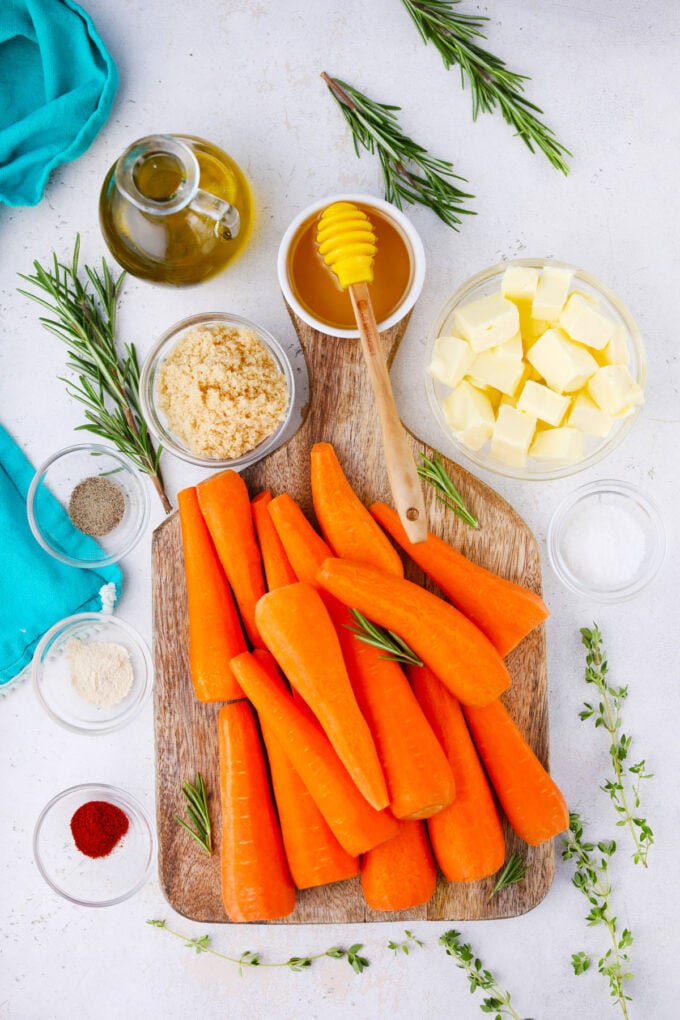 Overhead shot of brown sugar roasted carrots ingredients in bowls on a table.