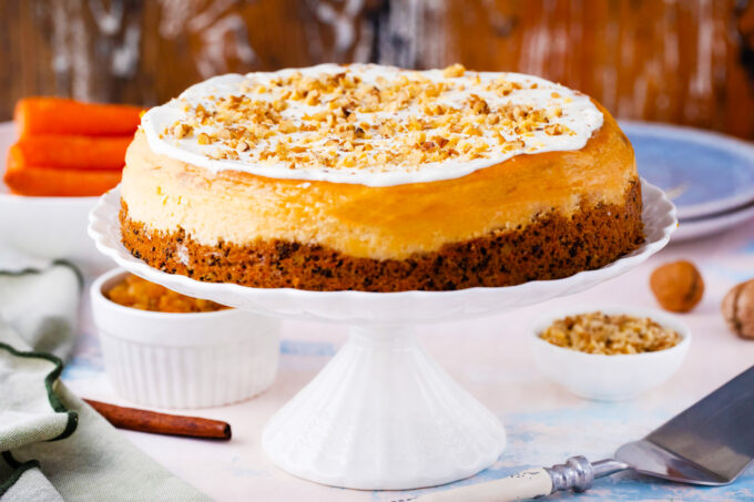 Carrot cake cheesecake on a cake stand.