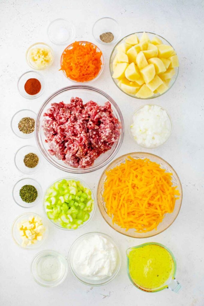 cheeseburger soup ingredients in bowls on a table