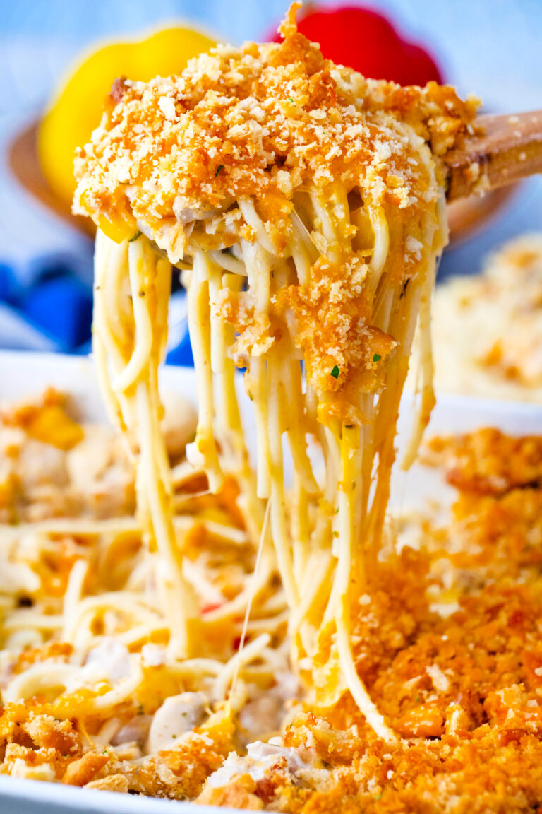 A spoonful of very cheesy and creamy baked chicken spaghetti casserole.