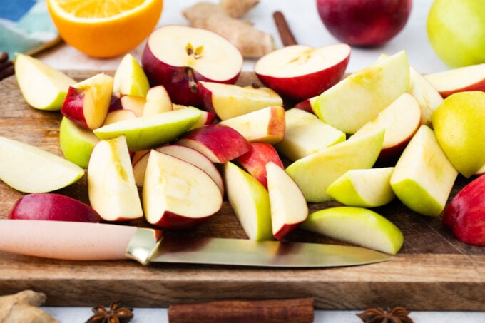 Slices apples on a cutting board.