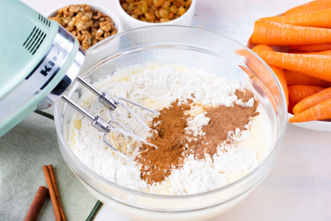 Combining wet and dry ingredients for carrot cake.