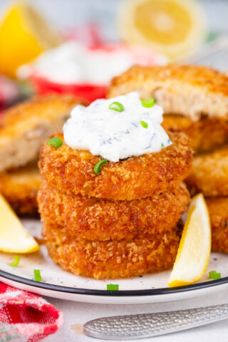 A stack of crispy crab cakes that are juicy on the inside and crunchy on the outside.