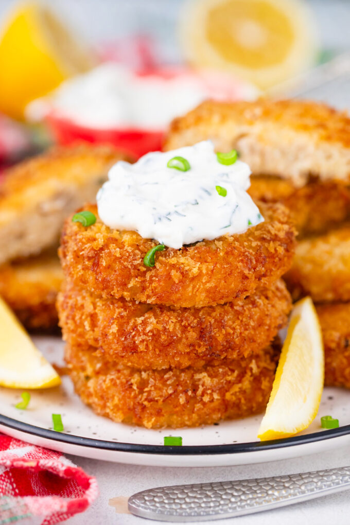 A stack of crispy crab cakes that are juicy on the inside and crunchy on the outside.