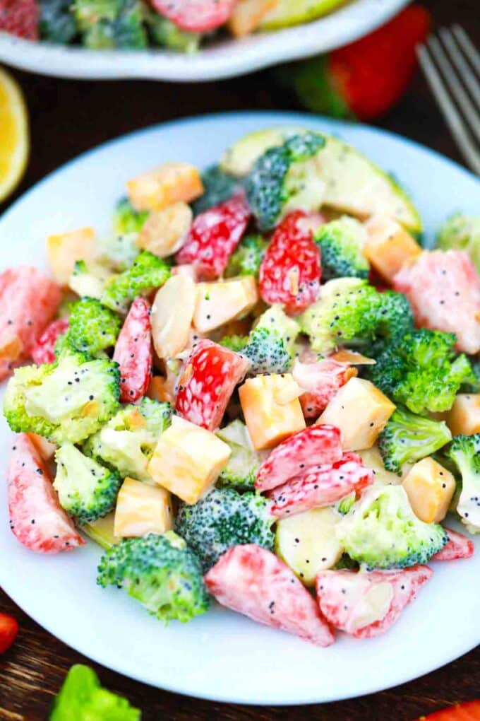 a plate of reamy strawberry broccoli salad