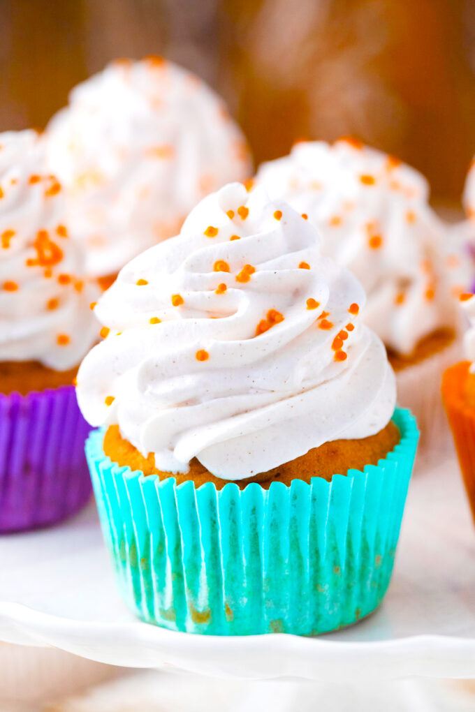 Sweet potato pie cupcakes topped with whipped cream.