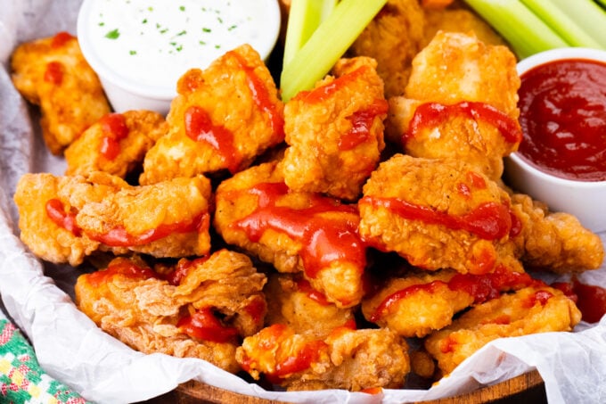 A platter of crispy boneless chicken wings with Ranch dressing.