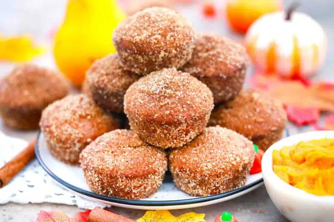 donut pumpkin muffins stacked on a plate