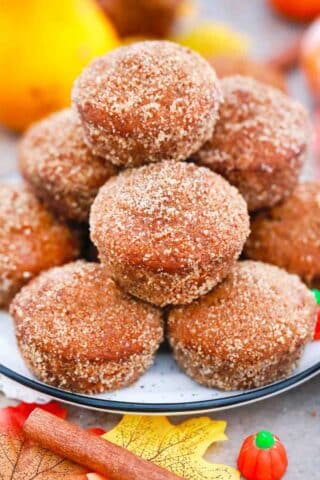 close shot of a stack of donut pumpkin muffins