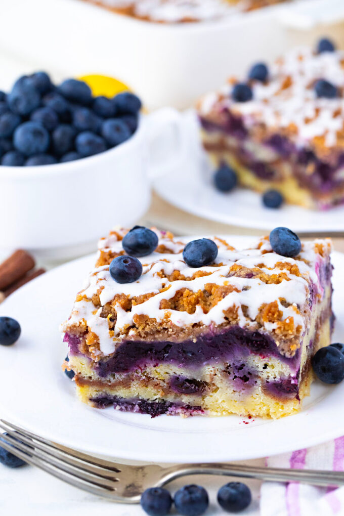 A slice of blueberry coffee cake on a plate.