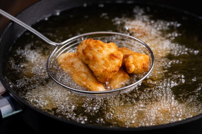Frying crispy boneless chicken wings.