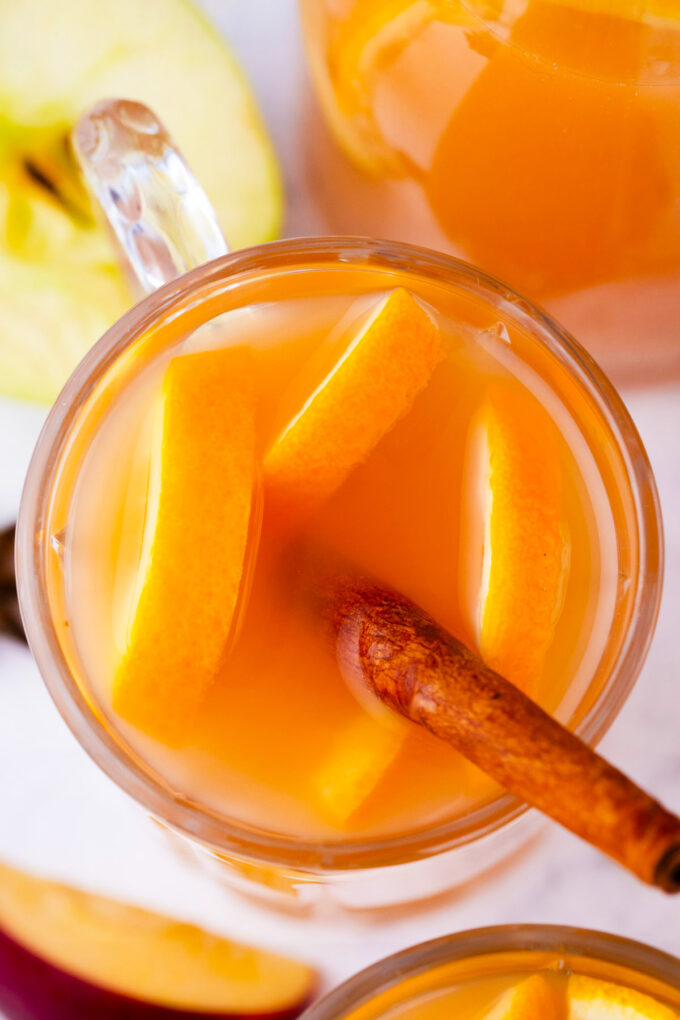 Homemade apple cider with cinnamon and oranges.