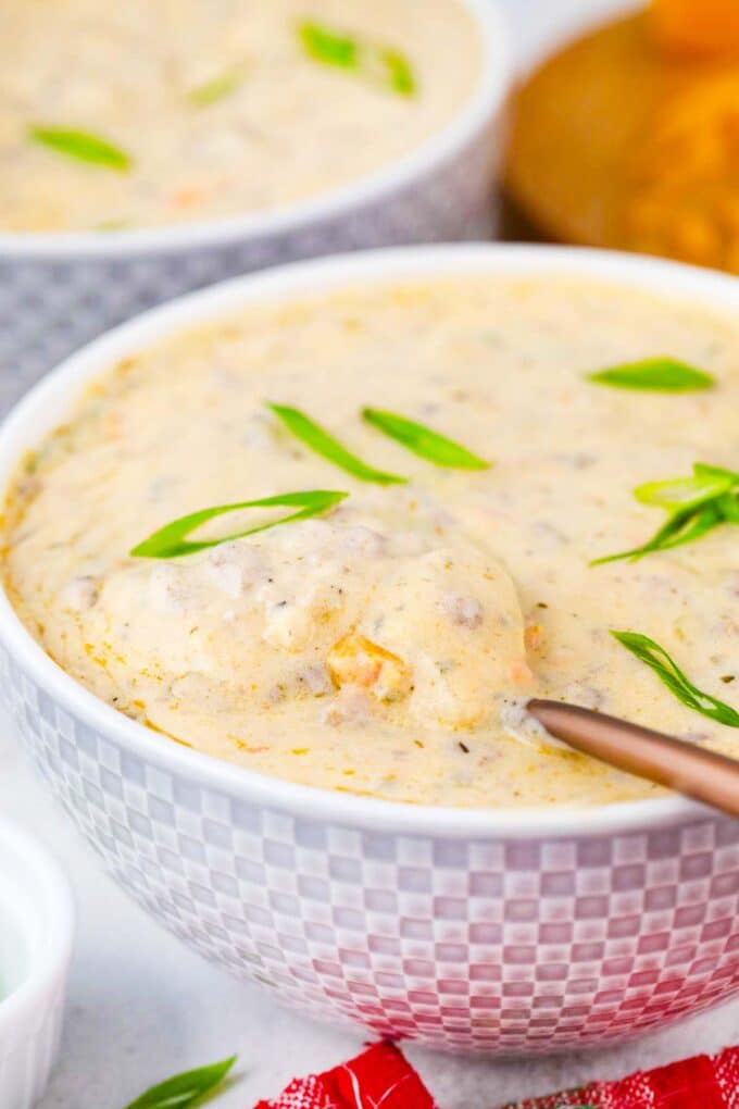 a bowl of cheeseburger soup with a spoon in it