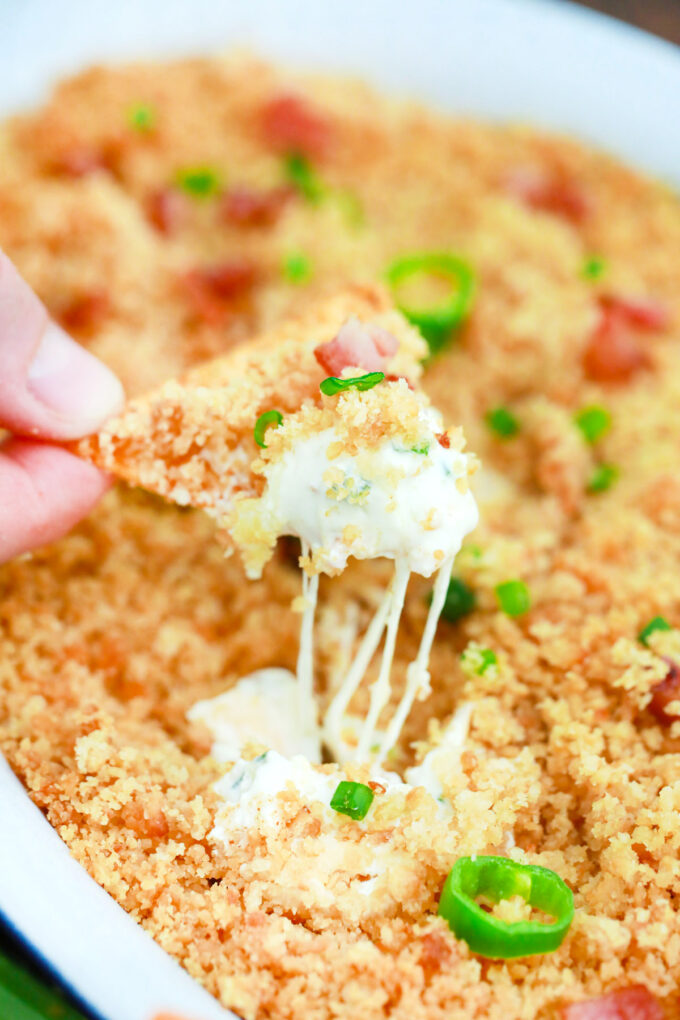 Corn chip dipped into homemade jalapeno popper dip.