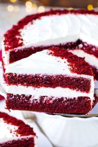 A slice of homemade red velvet cake on a serving spatula.
