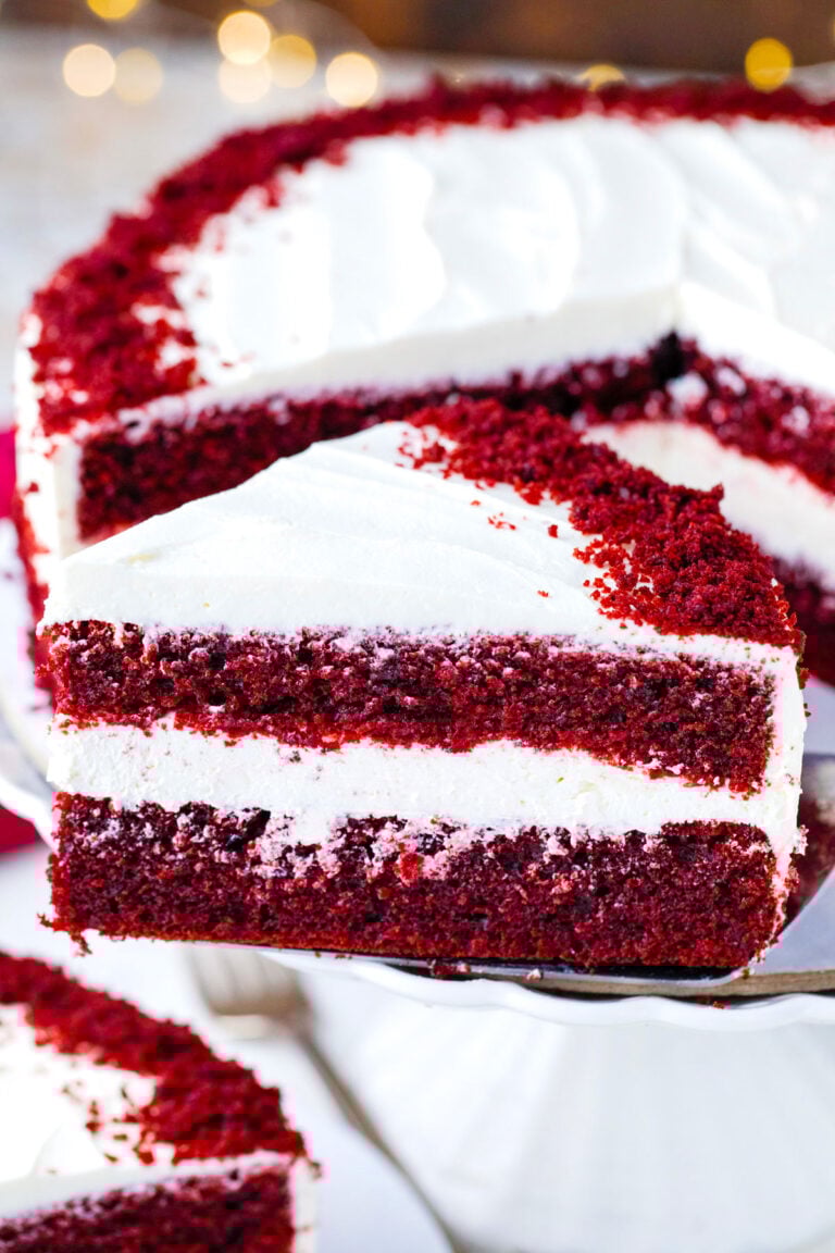 A slice of homemade red velvet cake on a serving spatula.