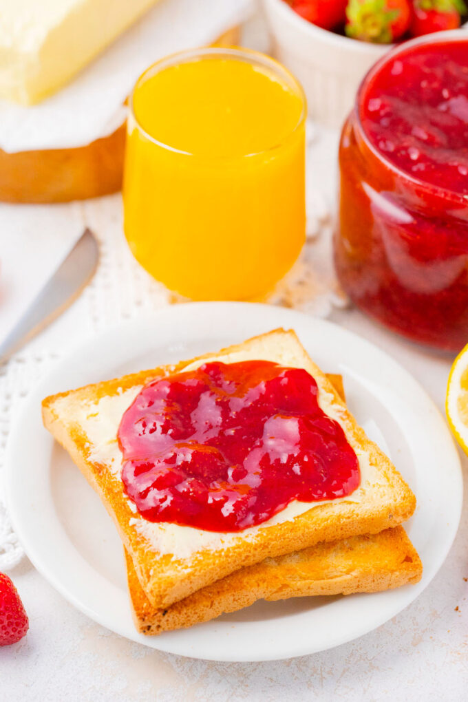 Homemade strawberry jam on toast with butter.