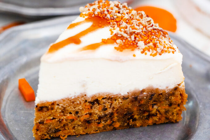 A slice of instant pot carrot cake cheesecake.