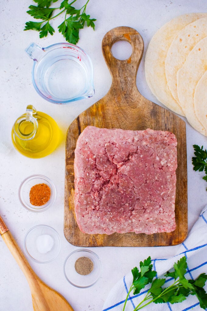 Instant pot frozen ground beef ingredients arranged on a white surface.
