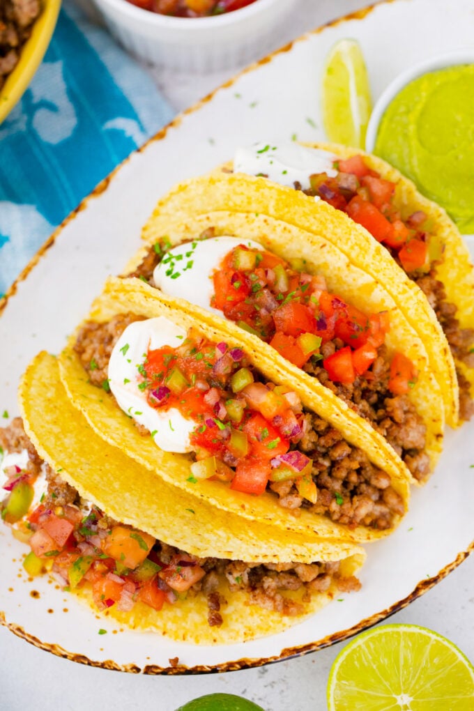 Tacos made with frozen beef that was cooked in the Instant Pot, topped with salsa and sour cream.