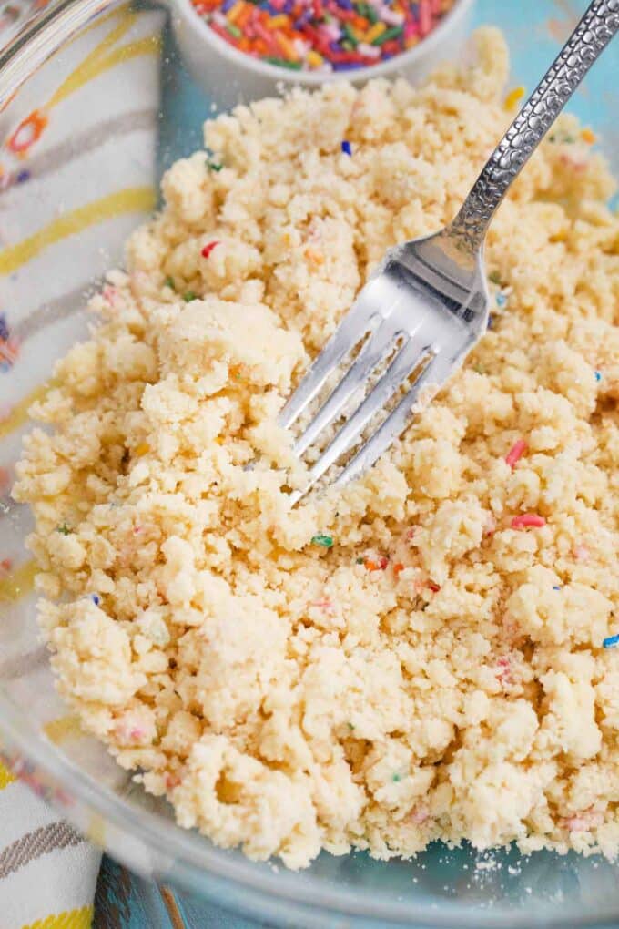 adding sprinkles to butter and flour mixture